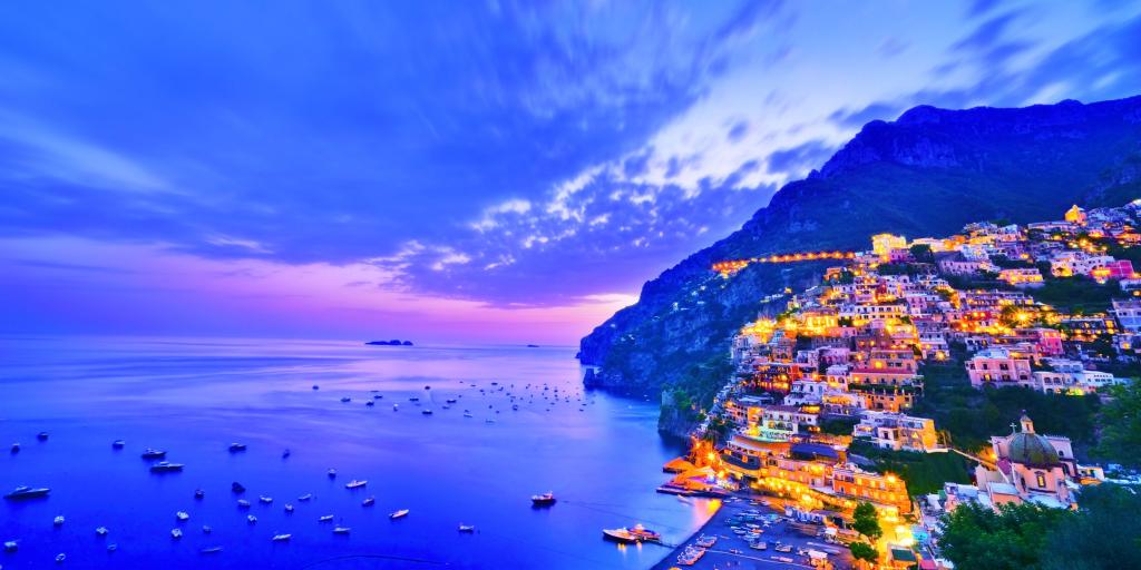 View of Positano village along Amalfi Coast in Italy at dusk