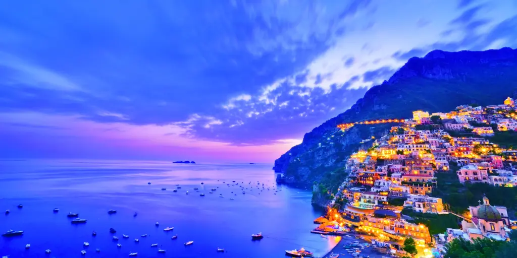 View of Positano village along Amalfi Coast in Italy at dusk