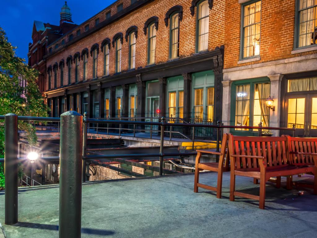 An old building and bench along River Street in Savannah Georgia.