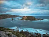 Lincoln National Park, South Australia with a view of the untouched western coastline, rocks in the foreground and in the distance surrounded by sea.