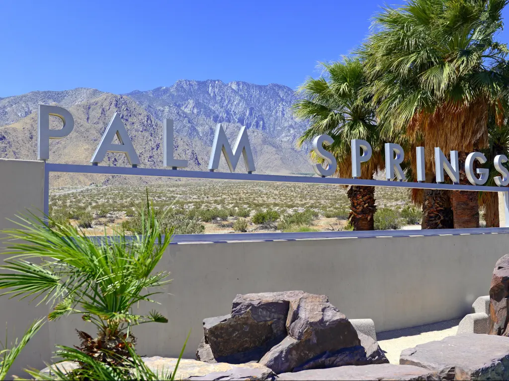 Palm Springs, California, USA with the Palm Springs sign, desert background and backdrop of San Jacinto Mountain on a clear sunny day.