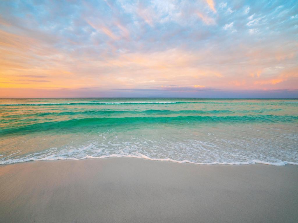 Bright green waters on Destin Beach during morning sunrise