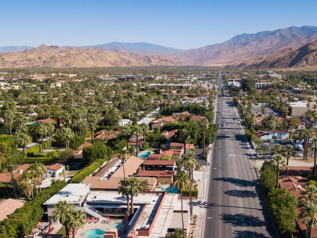 Palm Springs, California, USA with an aerial view of the downtown city with the mountains in the distance and taken on a sunny day.