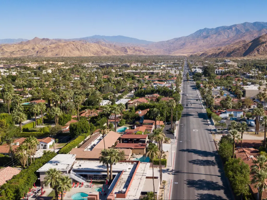 Palm Springs, California, USA with an aerial view of the downtown city with the mountains in the distance and taken on a sunny day.