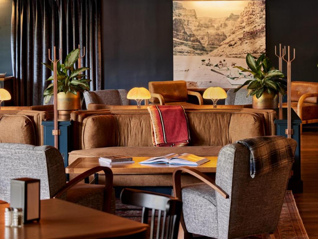 Modern lobby sitting area, with dark walls, contemporary furnishings and comfortable seating areas, within High Country Motor Lodge