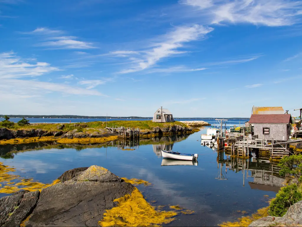 Nova Scotia, Canada with a typical scenic, small fishing village and harbor in the Maritimes, with lots of blue water and skies.