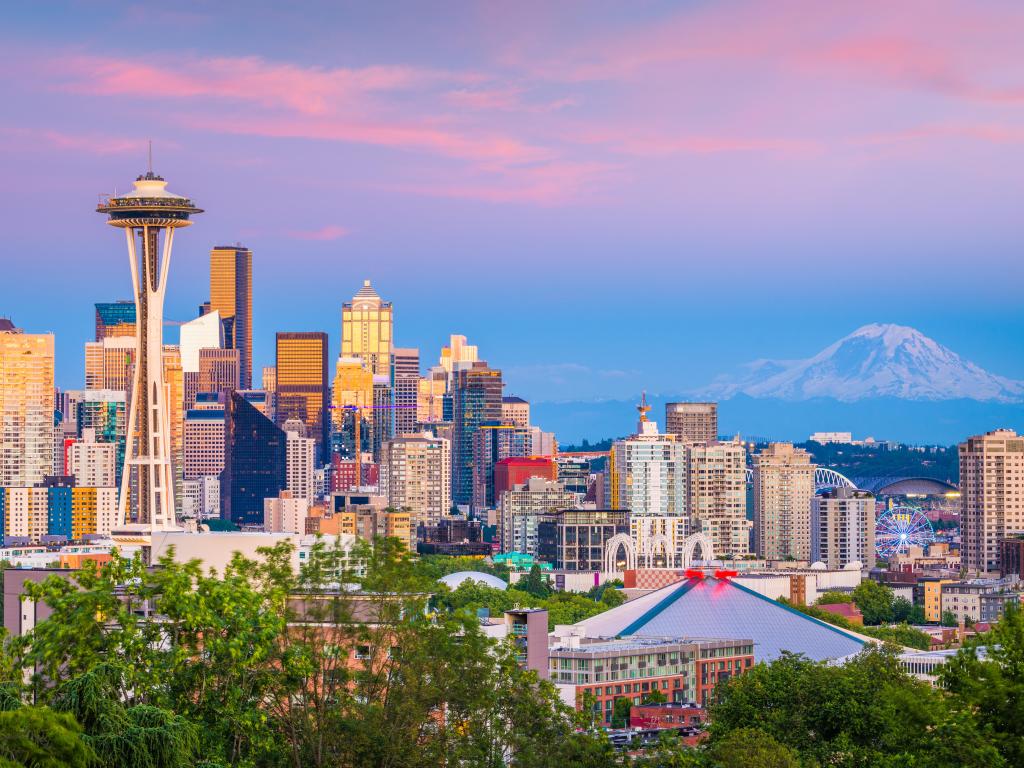 Seattle, Washington, USA downtown skyline at night with Mt. Rainier.