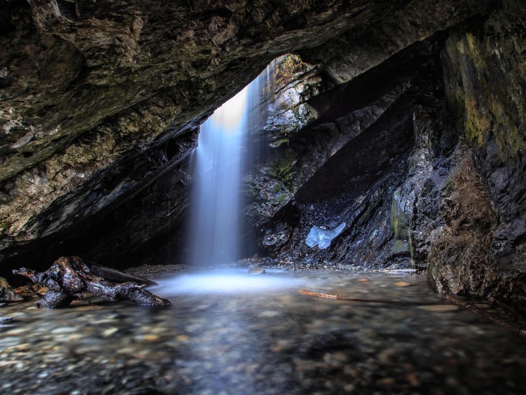 Big Cottonwood Canyon, Utah, USA taken at Donut Falls which is a very unique waterfall in Big Cottonwood Canyon Utah. The top flows right into the hole of a cave before making its decent down the rest of the falls.