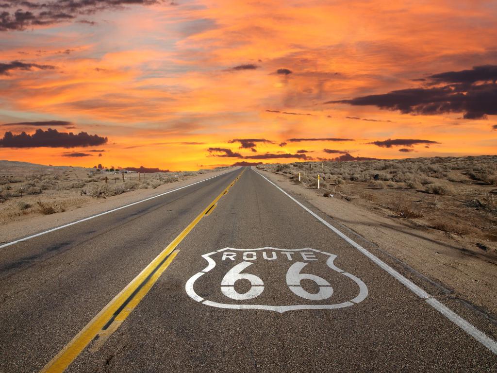 Route 66 pavement sign sunrise in California's Mojave desert.