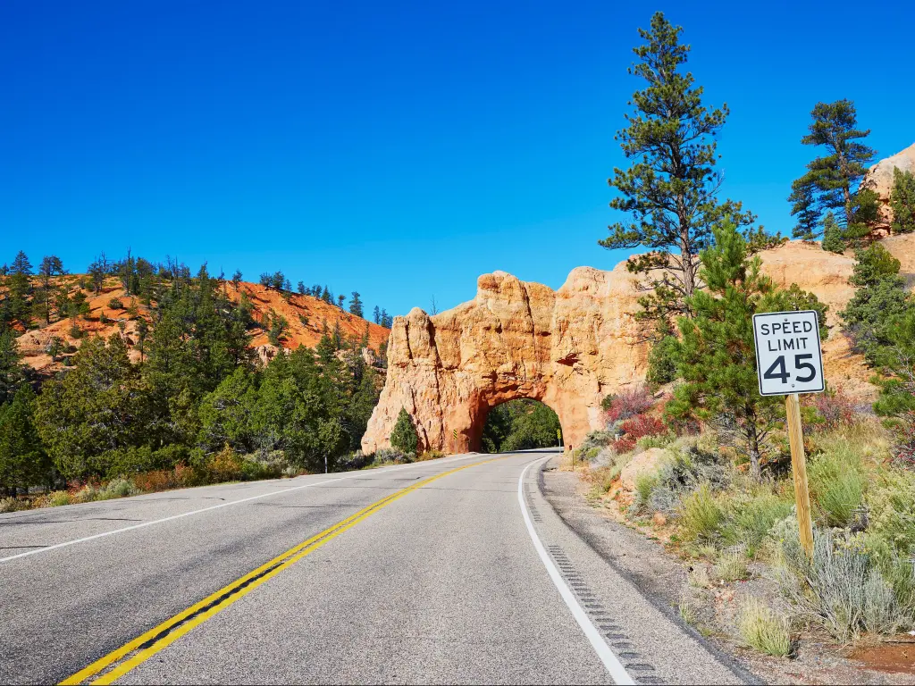 Scenic view of stunning red sandstone natural bridge and asphalt road in Bryce Canyon National Park in Utah, USA