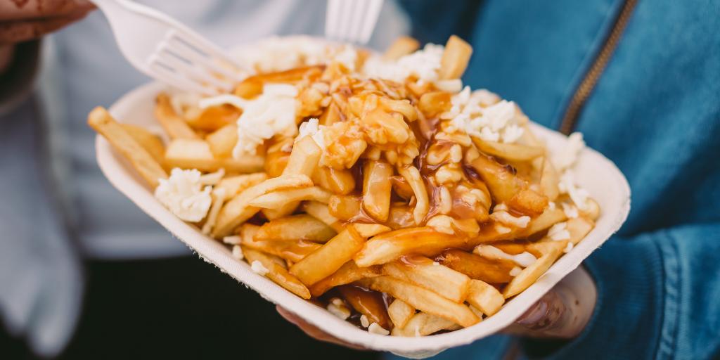 People eating poutine with plastic forks 