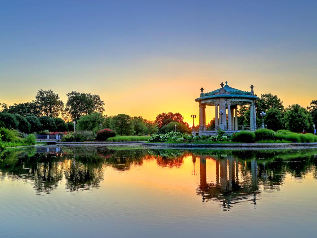 St. Louis, Missouri, USA taken at the bandstand in Forest Park at sunset with a lake reflecting in the foreground. 