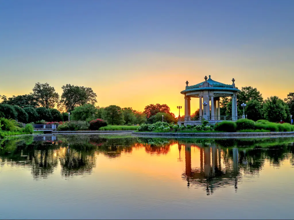 St. Louis, Missouri, USA taken at the bandstand in Forest Park at sunset with a lake reflecting in the foreground. 