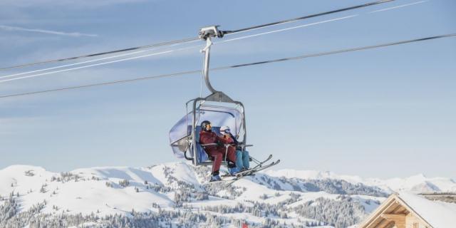 Two people in a chairlift at Gstaad, Switzerland