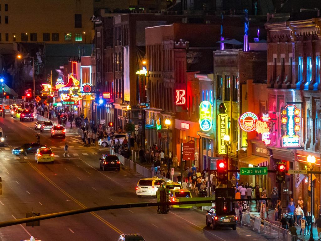 Nashville, Tennessee, USA with neon signs light the strip along Broadway at night.