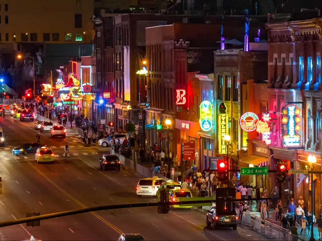 Nashville, Tennessee, USA with neon signs light the strip along Broadway at night.