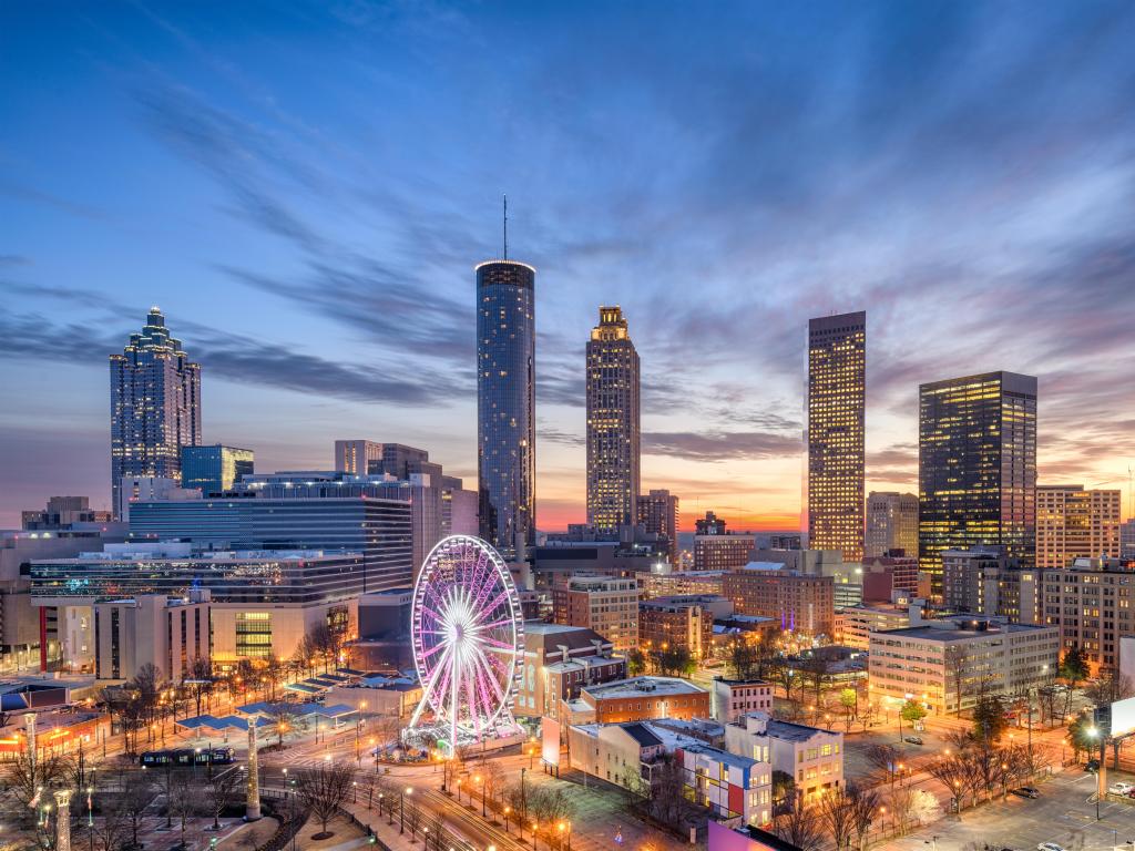 Atlanta, Georgia, USA with the downtown city skyline, the ferris wheel in the foreground and taken at early evening. 
