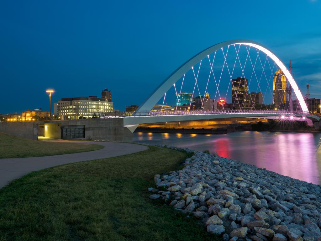 Des Moines, Iowa, USA taken at the Iowa Women of Achievement Bridge reflecting on the Des Moines River at night.