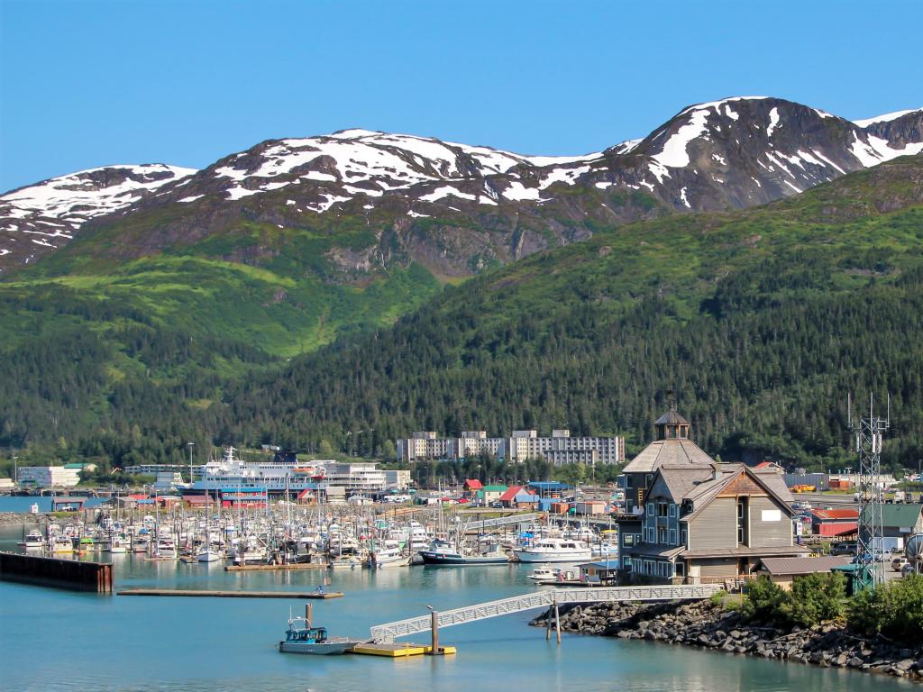 Whittier, Alaska with Prince William Sound in the foreground and mountains behind and boats on the water