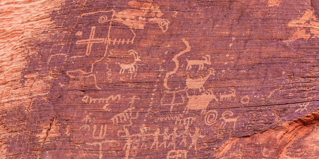 Ancient petroglyphs on red rock in Valley of Fire State Park, Nevada, U.S.A