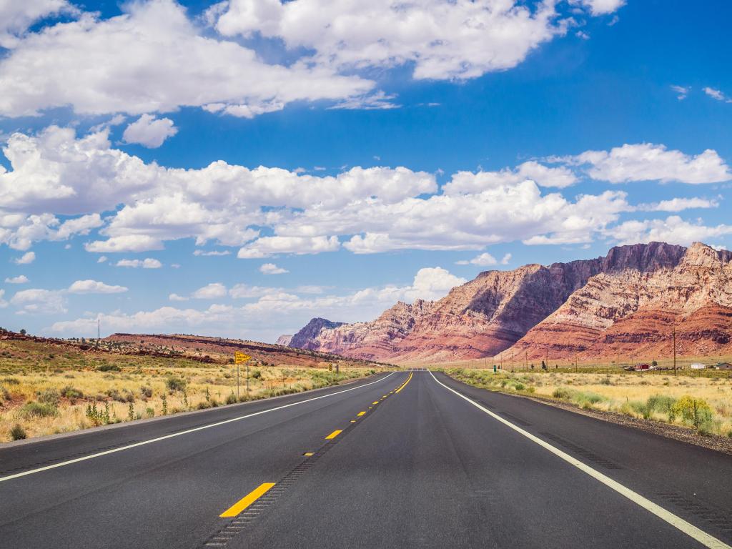 Picturesque road in Arizona. Red stone cliffs and blue sky.