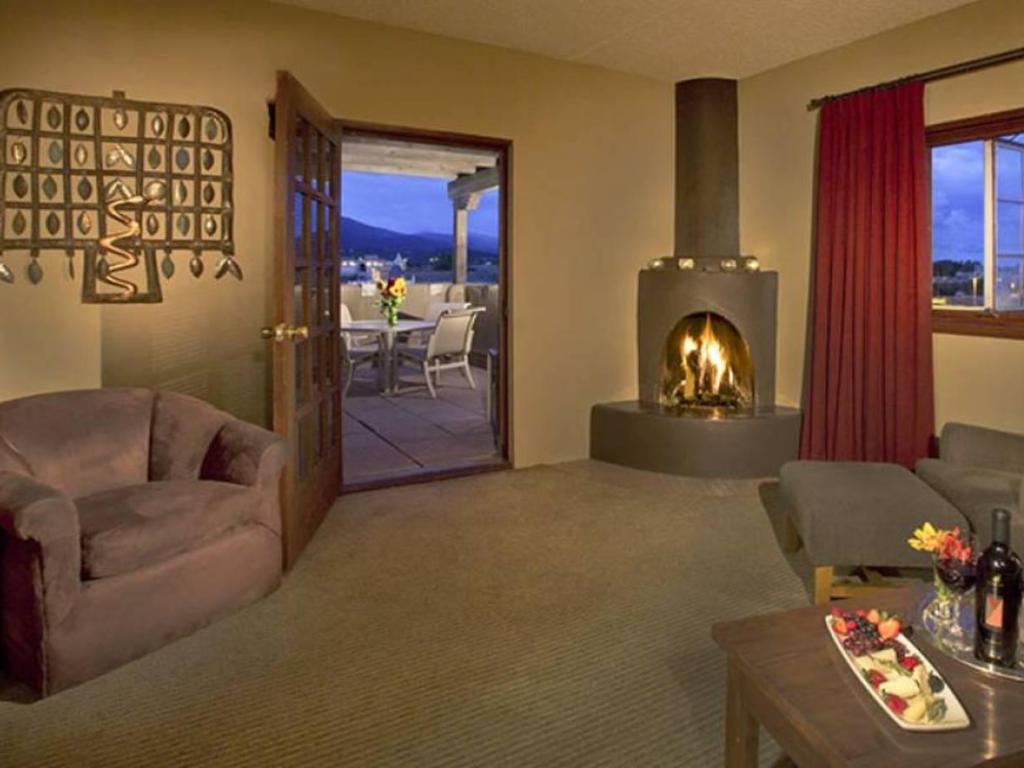 Luxury Premium Suite at Eldorado Hotel and Spa, with cozy fireplace, lounge area, and private terrace