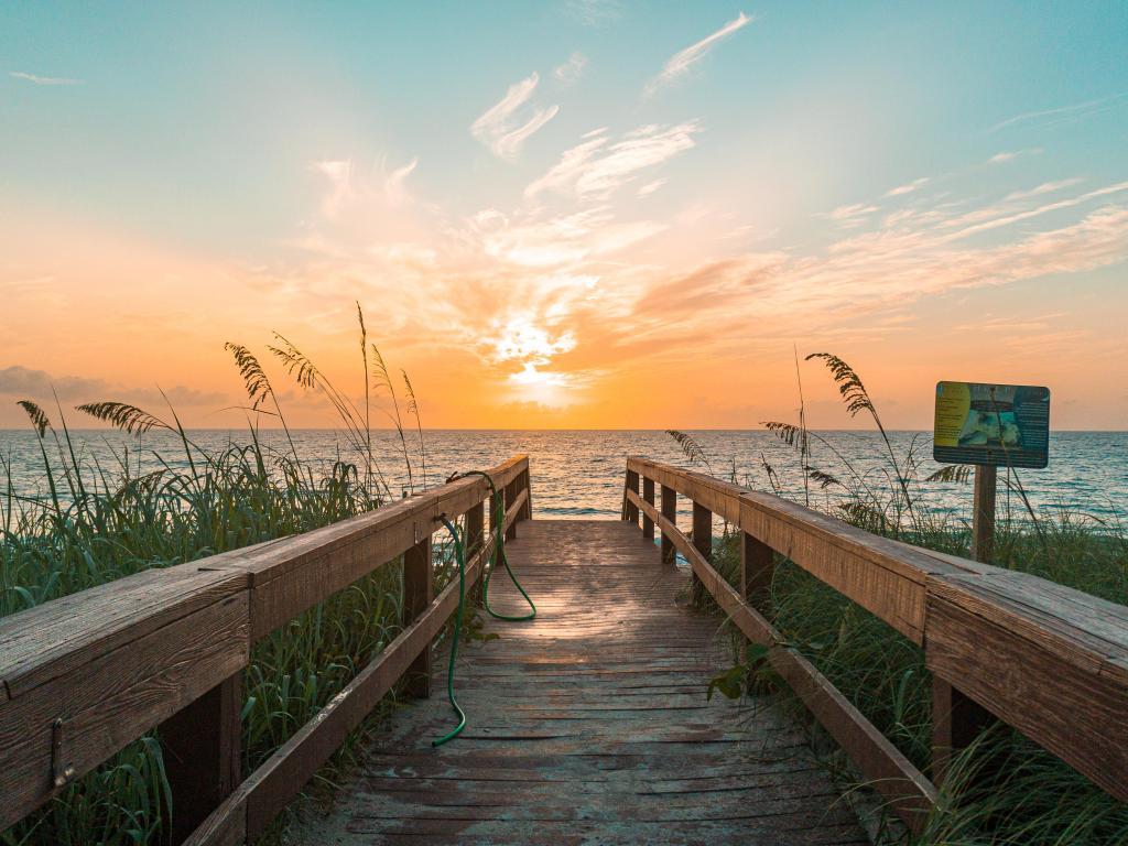 Jensen Beach, Martin County, USA with the beach trail through the sand dunes leading to the sea at sunset on a clear evening. 