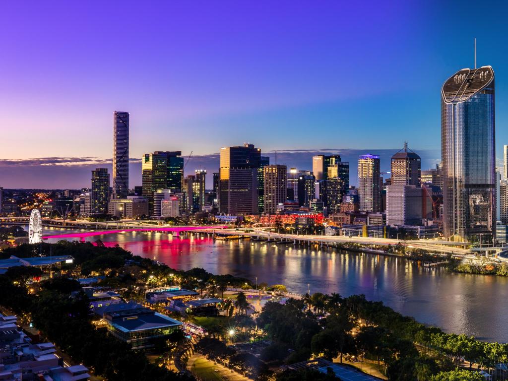Brisbane, Queensland, Australia at early evening with the city in the foreground and background and the river running between them.