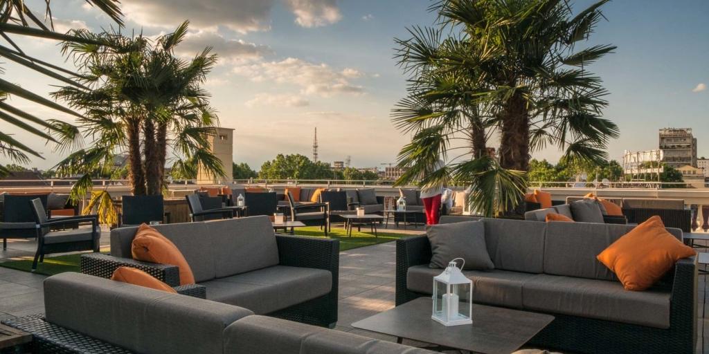 Grey sofas on the Turin Palace Hotel rooftop terrace