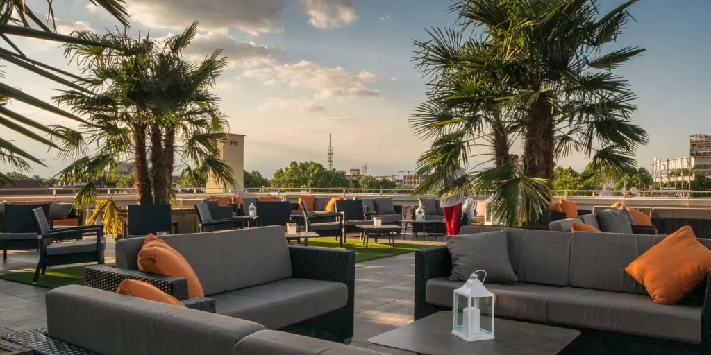 Grey sofas on the Turin Palace Hotel rooftop terrace
