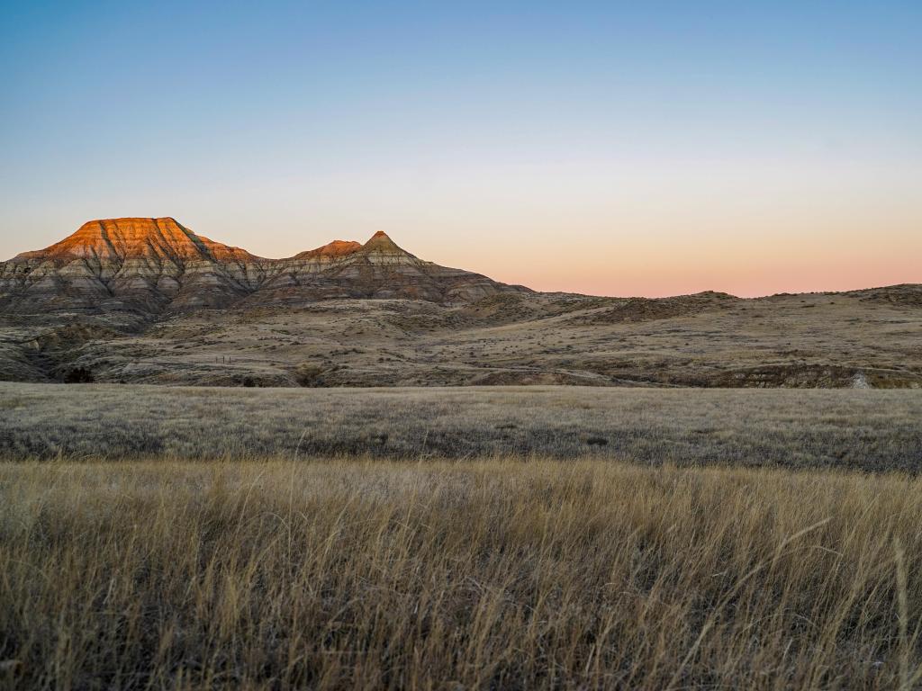 Alpenglow on badlands mountain cliffs in Eastern Montana, near Miles City, during sunrise 