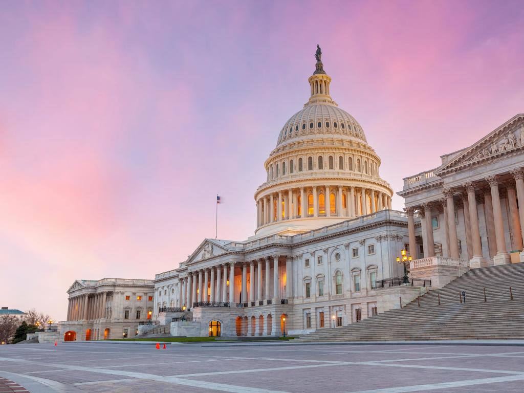 Washington DC, USA with a sunset shot of The United States Capitol Building.