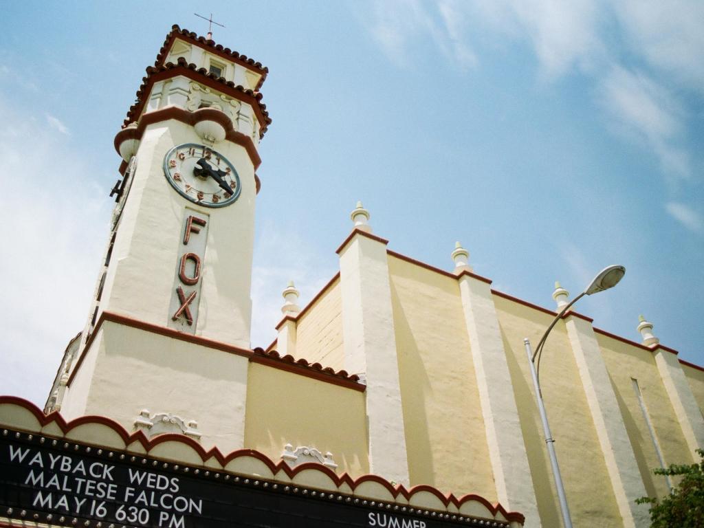 The facade and clock tower of the historic building on a sunny day