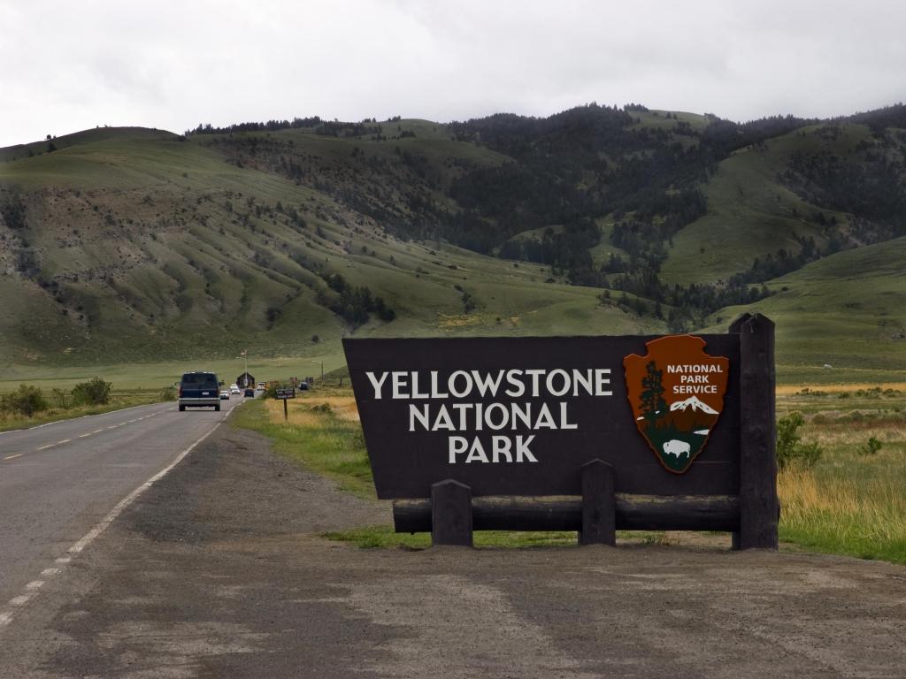 North entrance sign to Yellowstone National Park on an overcast day in spring