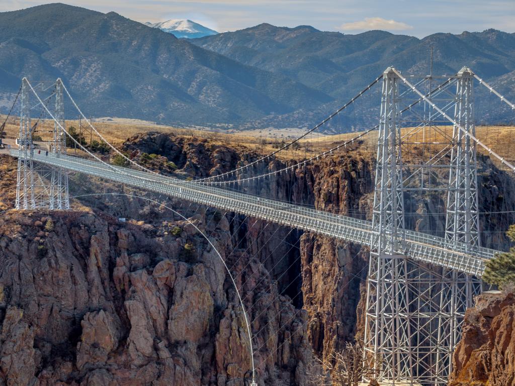 Colorado's Royal Gorge Bridge, with snow capped mountains in the background