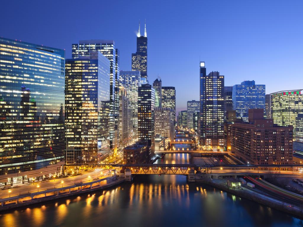 Chicago, Illinois, USA with the downtown city and Chicago River with bridges during sunset.