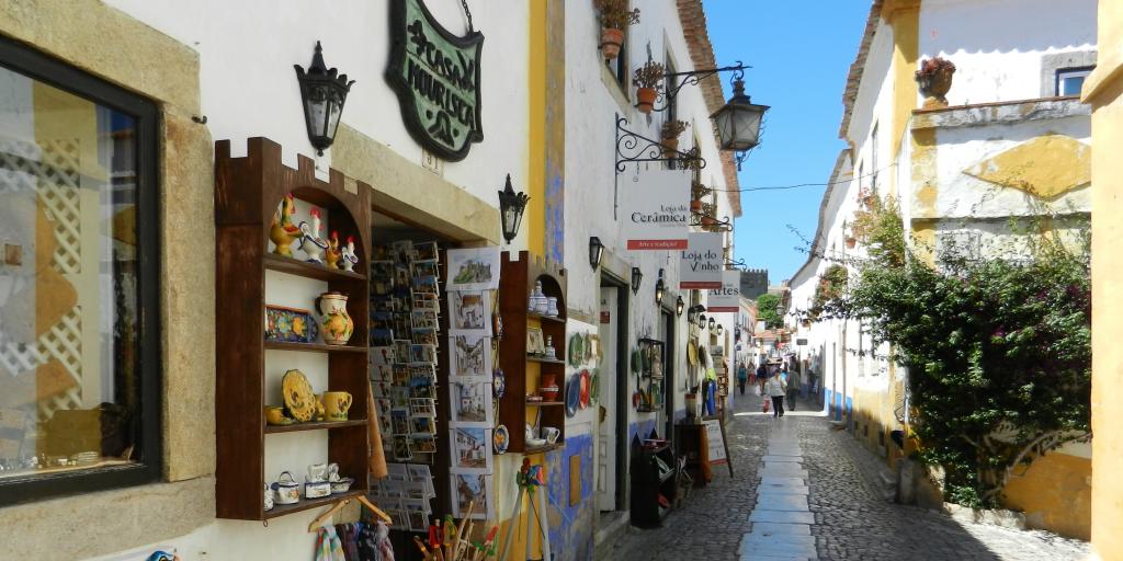 Cobbled street with gift shops in Obidos, Portugal 