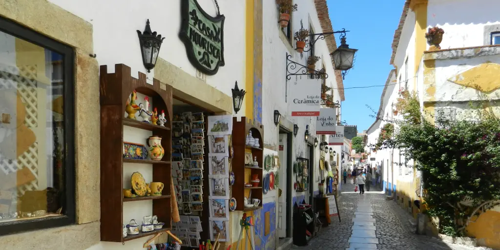 Cobbled street with gift shops in Obidos, Portugal 