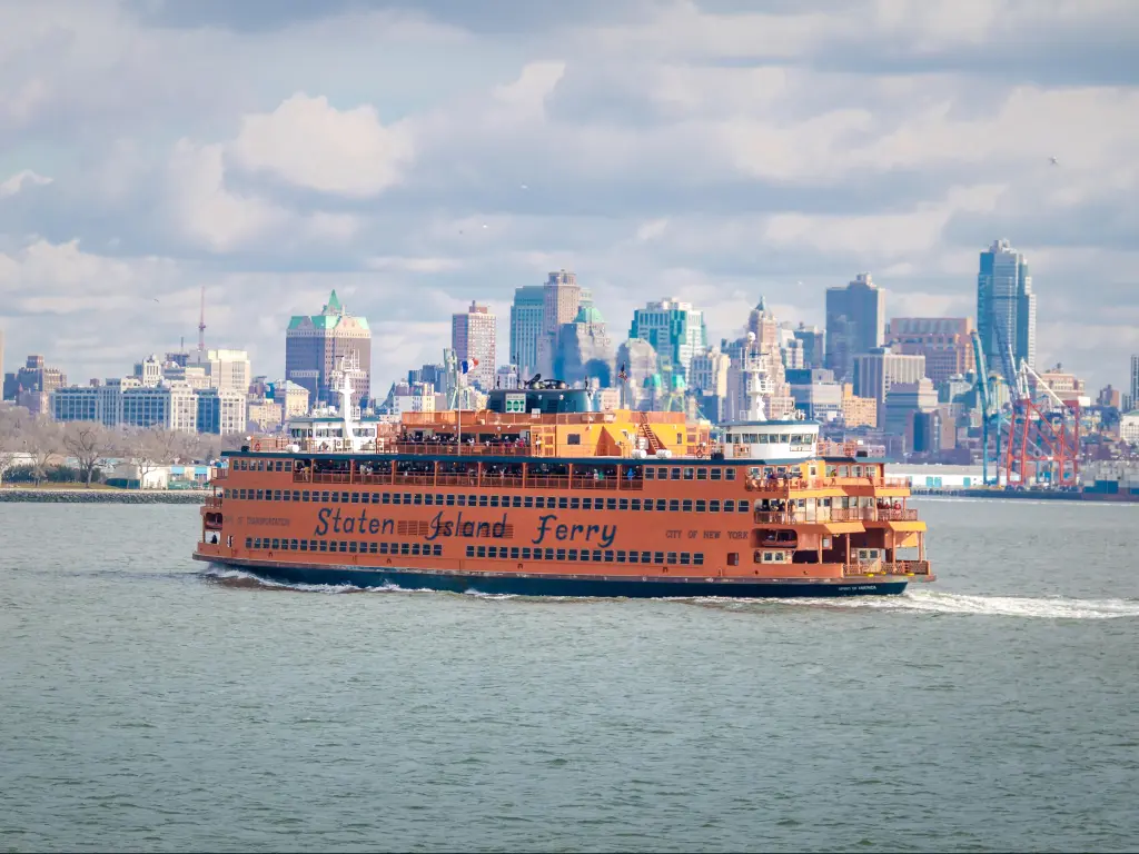 Staten Island Ferry and Lower Manhattan Skyline on a cloudy day.