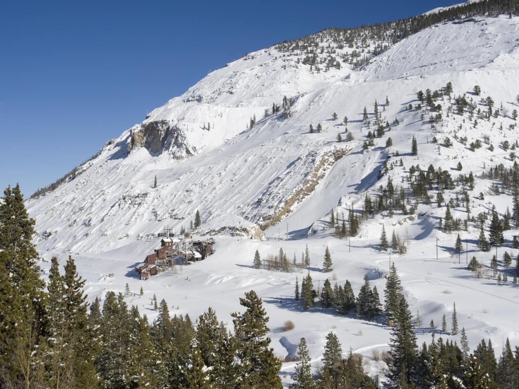 A snowy landscape shot of the Madonna Mine, located just below the top of Monarch Pass