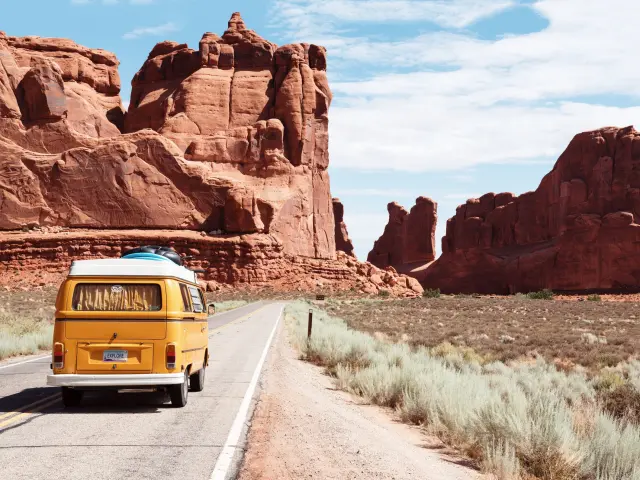 Road trip past rocks in the middle of the desert