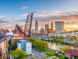 Cleveland, Ohio, USA skyline on the river at sunset.