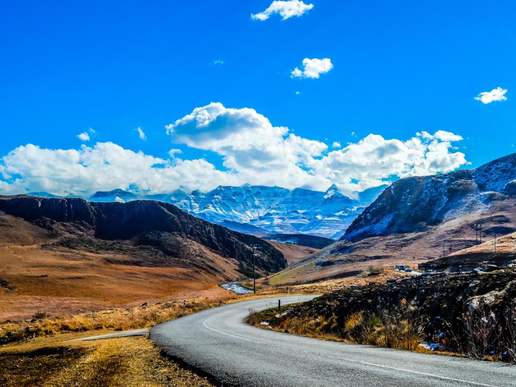 Snow landscape in Drakensberg mountains in Underberg South Africa under blue sky and clouds