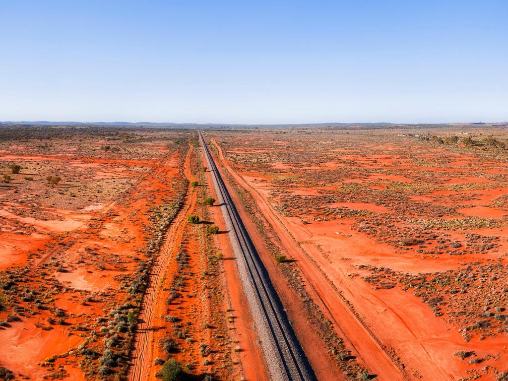 Wide landscape of red soil outback near Broken hill in Australia over railway road track and Barrier highway.