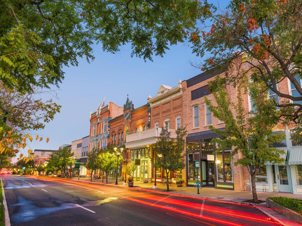 Provo, Utah, USA downtown on Center Street at dusk with trees surrounding the view.