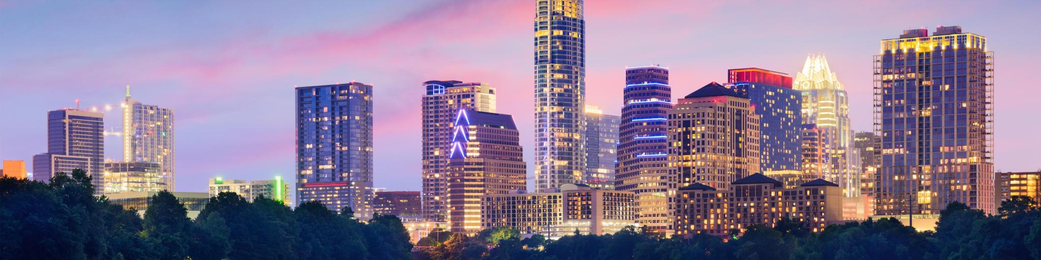 Austin, Texas, USA downtown skyline on the Colorado River at night.