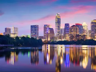 Austin, Texas, USA downtown skyline on the Colorado River at night.