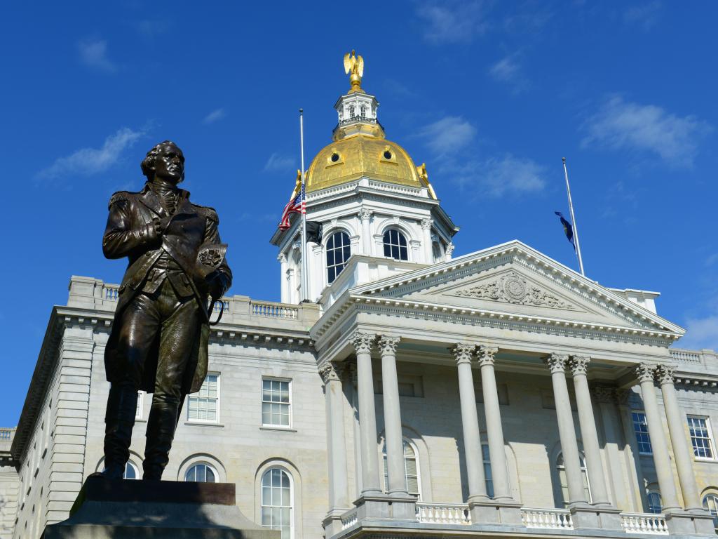New Hampshire State House, Concord, New Hampshire, with blue sky behind the statue