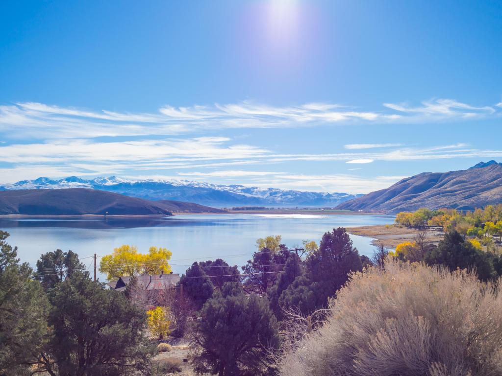 Glistening waters of Topaz Lake, Nevada, with snow capped mountains behind