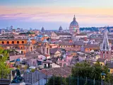 Rome rooftops and landmarks colorful sunset view, capital city of Italy